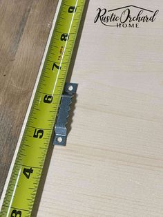 a ruler is sitting on top of a piece of wood