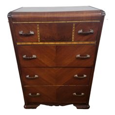 an antique chest of drawers with brass hardware on the top and bottom, in walnut