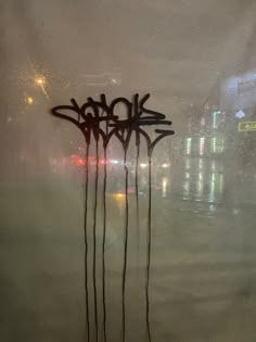 graffiti is spray painted on the window of a building