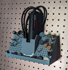 an electronic device is hooked up to a pegboard