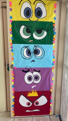 a door decorated to look like the faces of characters from disney pixama and monsters