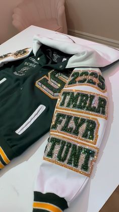 Cheer Team Jackets, Blinged Out Letterman Jacket, Varsity Patch Ideas, Senior Night Cheer Outfits, Senior Hoodies Design Ideas 2025, Senior Hoodie Ideas, Bedazzled Clothing, Senior Varsity Jacket, Varsity Jacket Ideas