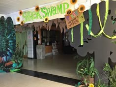 the entrance to a store decorated with sunflowers and paper streamers that say shr's swamp