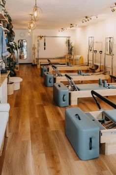 a room filled with lots of blue luggage on top of hard wood floored floors