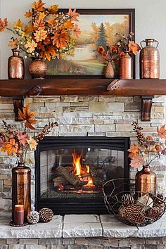 the fireplace is decorated with autumn leaves and copper vases