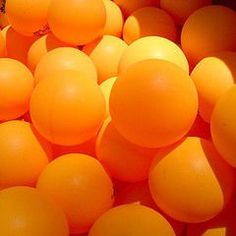 there are many orange balls in the bins that are full of them and have been placed together