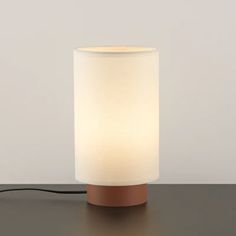 a lamp that is sitting on top of a table with a cord attached to it