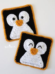 two crocheted penguin coasters sitting next to each other