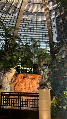 the inside of a building with plants and trees