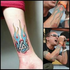 a man with a tattoo on his arm singing into a microphone