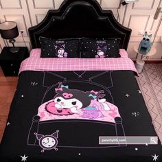 a bed with black and pink comforters on it