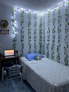 a bed room with a neatly made bed and string lights on the wall behind it