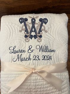 a wedding blanket with the initials and date on it