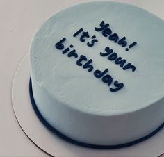 a white cake with blue frosting that says it's your birthday