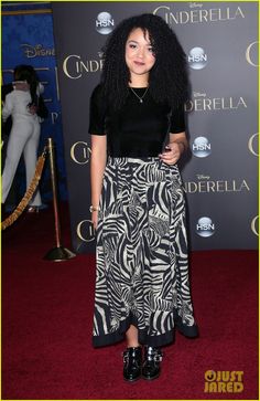 a woman with long black hair standing on a red carpet in front of an advertisement for cinderella