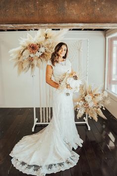 a woman in a wedding dress holding flowers