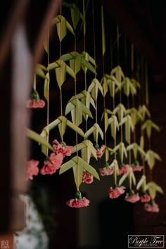 pink flowers hanging from the ceiling in a room