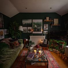 a living room filled with furniture and pictures on the wall above it's fireplace