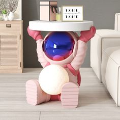 a pink and white toy sitting on top of a table