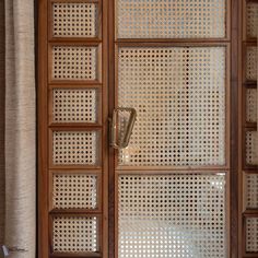 an open wooden door with glass panels on it