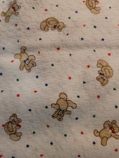 the teddy bears are all over the white sheet with red, blue and green dots