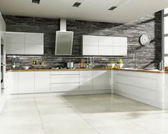 a modern kitchen with white cabinets and black counter tops, along with a large window