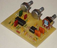 an electronic device with many components on top of it, including two knobs and some wires