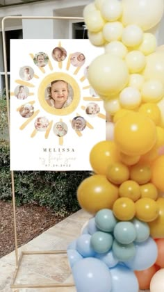 a bunch of balloons that are in front of a sign with a photo on it