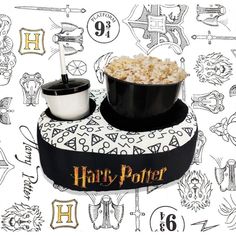 a harry potter hat with a bowl of popcorn in it on top of a table