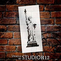 the statue of liberty stencil is shown on a brick wall in this image