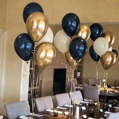 the table is set with black and white balloons