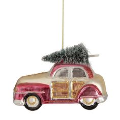 an ornament shaped like a car with a christmas tree on the roof, hanging from a chain