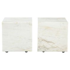 two white marble cubes with black wheels