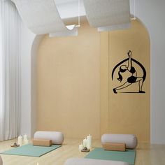 a room with yoga mats and candles on the floor