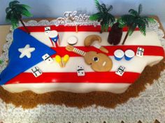 a birthday cake decorated to look like an airplane with flags and palm trees on top