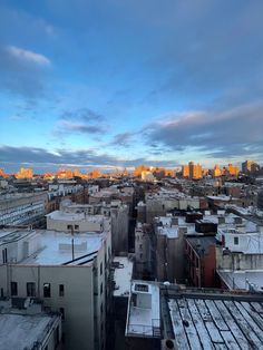 the city skyline is covered in snow at sunset