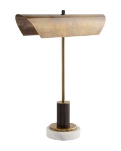 a lamp that is sitting on top of a white base and has a brown shade over it