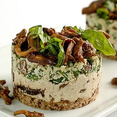 two small desserts on a white plate with pecans around the edges and toppings