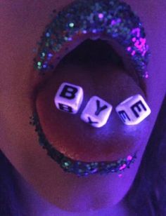 a close up of a person's mouth with diced letters on it that spell out the word blym