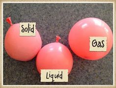 two pink balloons with words on them that say, sold and sold liquid or gas