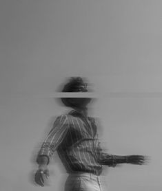 a blurry image of a man riding a skateboard