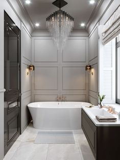 a bathroom with a large tub and chandelier