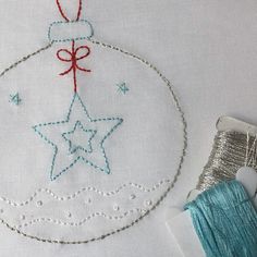 a christmas ornament and thread on a table