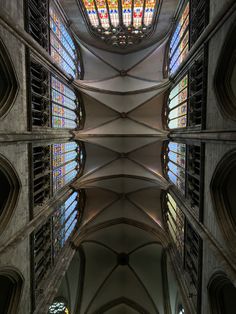 the inside of a cathedral with stained glass windows