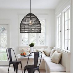 a living room with white walls and furniture