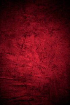 a dark red background with some stains on it