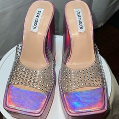 Steve Madden Ruby Iridescent Jeweled Platform Sandal Block Heeled Mule Sz 9 Stunning! Definitely A Statement Shoe! This Completes The Outfit! These Heels Are As Glam As It Gets With A Stunning Iridescent Pink Covered Platform & Soaring Block Heel With Rhinestone Embellished Vamp Color Iridescent Pink W Silver Jewels Platform Slip-On Mule Sandal Embellished With Rhinestones Over A Clear Vamp Square Open-Toe Block Heel Height 5.75" No Box * See Last Slide For Minor Indents(2) On Right Heel Tags: R Dress Boots Women, Block Heel Mule, Platform Shoes Heels, Heeled Mule, Rhinestone Heels, Statement Shoe, Leather Platform Sandals, Leather Slide Sandals, Mary Jane Pumps