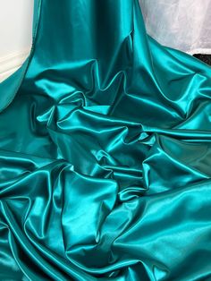 "TEAL ACETATE SATIN FABRIC Product information 1 mtr teal quality acetate satin fabric 45\" wide 114cm Ideal for decorations,dress making,bridal,dresses,dress lining,waistcoats,jackets,table runners,crafts, and many other projects Sold by the mtr If more than one quantity is bought it will be sent as one continous length" Drape Fabric, Dress Drape, Elegant Fabric, Teal Fabric, Net Fabric, Stunning Gowns, Dress Satin, Leopard Print Dress, Gold Shimmer