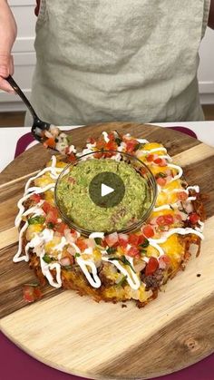 a person cutting up food on top of a wooden board