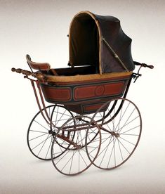 an old fashioned baby carriage is shown on a white background